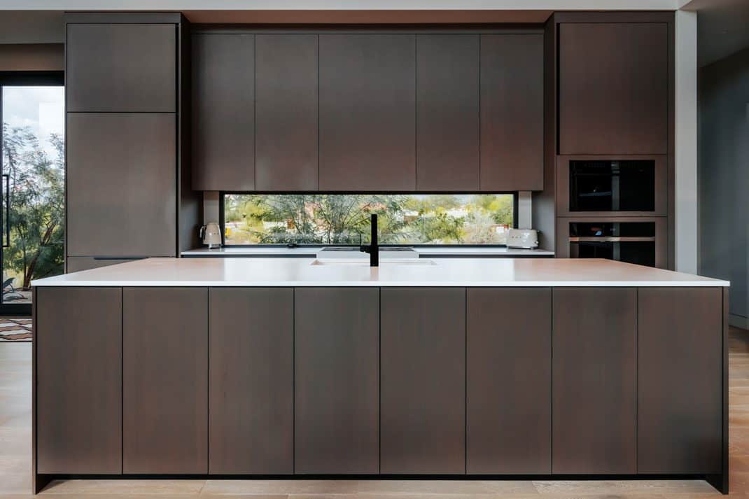 Modern kitchen with large central island and minimalist contemporary cabinetry