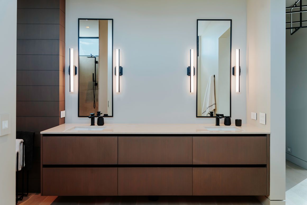 Primary bathroom vanity with double vessel sinks and clean minimalist millwork